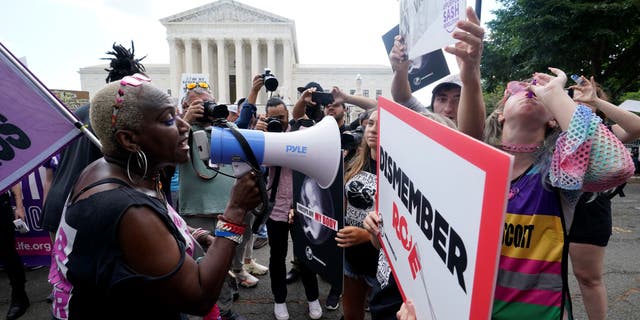 People protest about abortion, Friday, June 24, 2022, outside the Supreme Court in Washington.