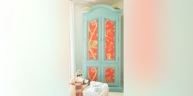 This image released by Kyle Caldwell Photography shows a dresser refinished with paint and wallpaper from Mary Maloney of Bee’s Knees Interior Design in Hopkinton, Mass. Maloney reawakens old wooden furniture by painting it in cheery hues; she also often applies patterned papers. (Kyle Caldwell Photography via AP)