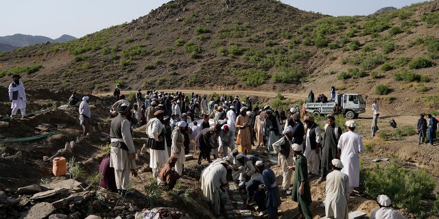 Afghans burry relatives killed in an earthquake to a burial site l in Gayan village, in Paktika province, Afghanistan, Thursday, June 23, 2022. A powerful earthquake struck a rugged, mountainous region of eastern Afghanistan early Wednesday, flattening stone and mud-brick homes in the country's deadliest quake in two decades, the state-run news agency reported.