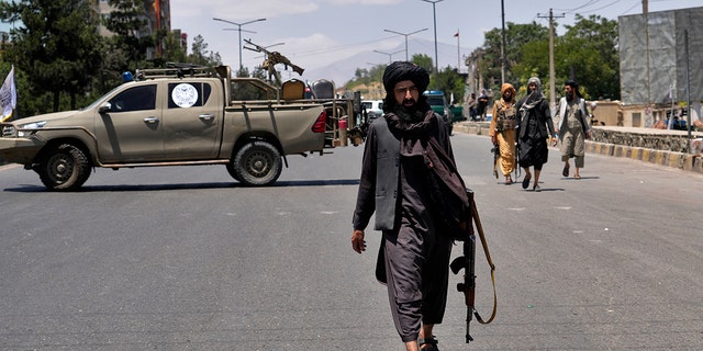 Taliban fighters guard at the site of an explosion in Kabul, Afghanistan, Saturday, June 18, 2022. Several explosions and gunfire ripped through a Sikh temple in Afghanistan's capital.