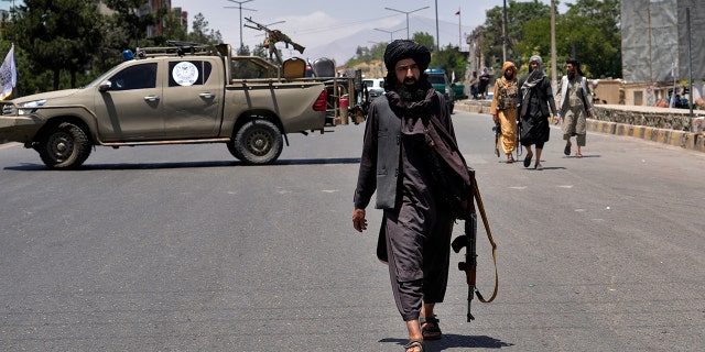 Taliban fighters guard at the site of an explosion in Kabul, Afghanistan, Saturday, June 18, 2022. Several explosions and gunfire ripped through a Sikh temple in Afghanistan's capital. (AP Photo/Ebrahim Noroozi)