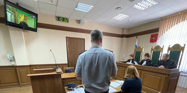 Russian opposition leader Alexei Navalny, seen on the TV screen, appears on a video link from prison provided by the Russian Federal Penitentiary Service in a courtroom in Vladimir, Russia, Tuesday, June 28, 2022