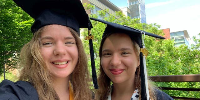 Alina and Anastasia Antropova tried on their graduation cap and gown together at the Holyoke Community College Campus Center.