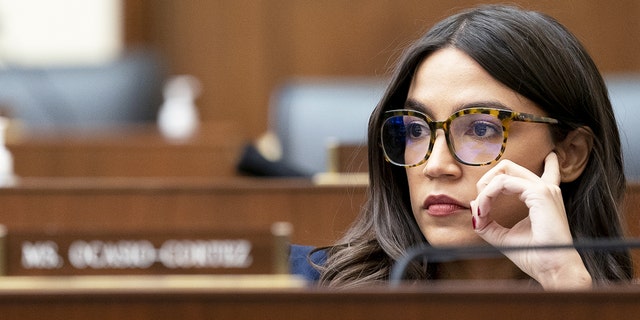 Rep. Alexandria Ocasio-Cortez, a Democrat from New York, listens during a House Financial Services Committee hearing in Washington, D.C., Dec. 8, 2021.