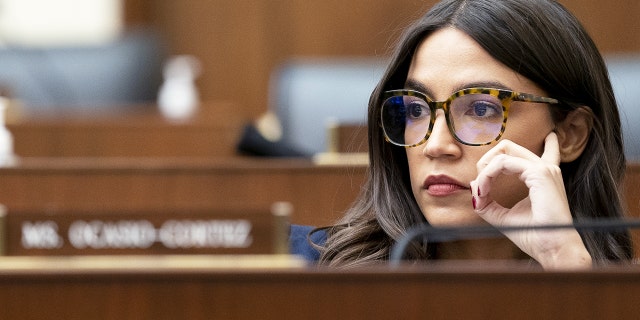 Rep. Alexandria Ocasio-Cortez, a Democrat from New York, listens during a House Financial Services Committee hearing in Washington, D.C., Dec. 8, 2021.