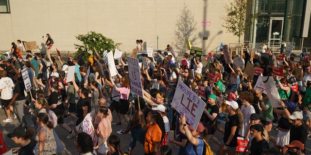 People march to protest the Supreme Court's decision in the Dobbs v. Jackson Women's Health case on June 24, 2022, in Atlanta, Georgia.