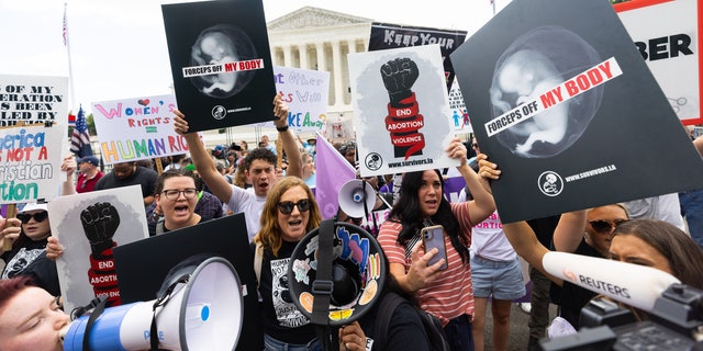 Pro-life crowd cheers over SCOTUS decision.