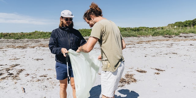 Surfer Anna Gudauskas and surf photographer Sarah Lee cleaning up beaches along the East Coast with the help of volunteers. 