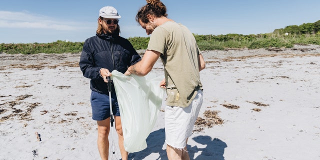 Surfer Anna Gudauskas and surf photographer Sarah Lee cleaning up beaches along the East Coast with the help of volunteers. 