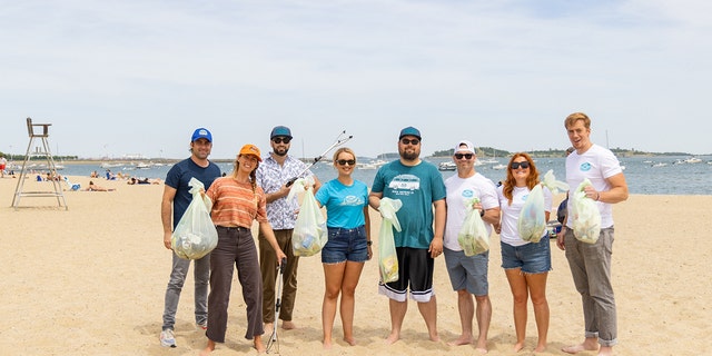 Surfer Anna Gudauskas and surf photographer Sarah Lee cleaning up beaches along the East Coast with the help of volunteers. 