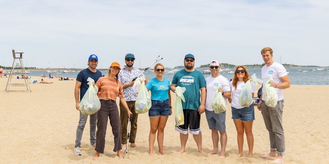 Surfer Anna Gudauskas and surf photographer Sarah Lee cleaning up beaches along the East Coast with the help of volunteers. 