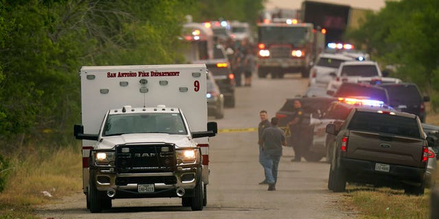 An ambulance leaves the scene where police said dozens of people were found dead in a semitrailer in a remote area in southwestern San Antonio, Monday, June 27, 2022. 