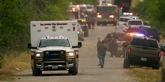 An ambulance leaves the scene where police said dozens of people were found dead in a semitrailer in a remote area in southwestern San Antonio, Monday, June 27, 2022.
