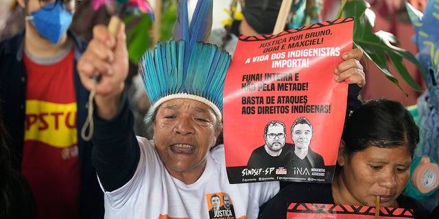 Guarani Indigenous and human rights activists rally in support of British journalist Dom Phillips and Indigenous expert Bruno Perreira, demanding authorities conduct a thorough investigation into the circumstances leading to their deaths, and do more to protect indigenous lands against illegal miners, loggers, and fishermen, in Sao Paulo, Brazil, Saturday, June 18, 2022. (AP Photo/Andre Penner)