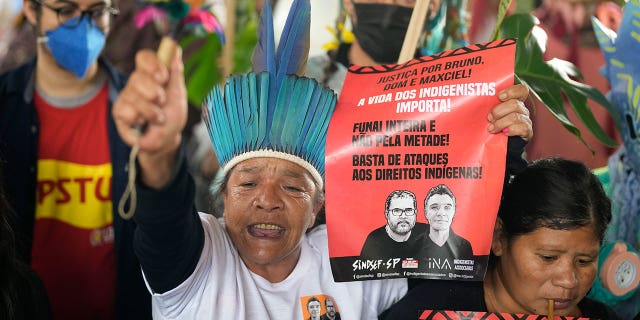 Guarani Indigenous and human rights activists rally in support of British journalist Dom Phillips and Indigenous expert Bruno Perreira, demanding authorities conduct a thorough investigation into the circumstances leading to their deaths, and do more to protect indigenous lands against illegal miners, loggers, and fishermen, in Sao Paulo, Brazil, Saturday, June 18, 2022. (AP Photo/Andre Penner)