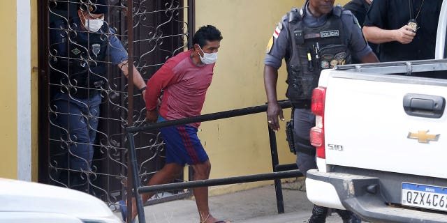 Oseney da Costa de Oliveira, 41, center, is brought out of the courthouse by military and civil police officers in Atalia do Norte, Amazonas state, Brazil, Wednesday, June 15, 2022. Police arrested Oseney da Costa de Oliveira and his brother Amarildo da Costa de Oliveira, so far considered by police as the main suspects in the disappearance of British journalist Dom Phillips and Indigenous expert Bruno Pereira. (AP Photo/Edmar Barros)