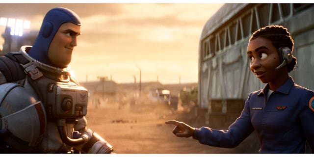 Buzz Lightyear, voiced by Chris Evans, and Alisha Hawthorne, voiced by Uzo Aduba, in a scene from the animated film "Lightyear," releasing June 17.