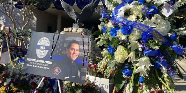 Hundreds gather at vigil remembering El Monte Cpl. Michael Paredes and Officer Joseph Santana, who were killed during a shootout. Critics have blamed Los Angeles District Attorney George Gascon.