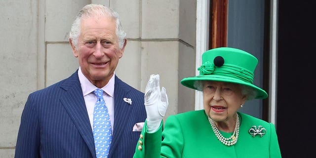 Britain's Queen Elizabeth and Prince Charles stand on a balcony during the Platinum Jubilee Pageant, marking the end of the celebrations for the Platinum Jubilee of Britain's Queen Elizabeth, in London, Britain, June 5, 2022