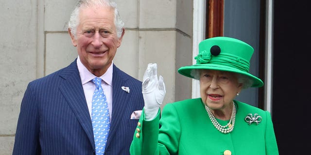 Queen Elizabeth and Prince Charles stand on a balcony during the Platinum Jubilee Pageant, marking the end of the celebrations.