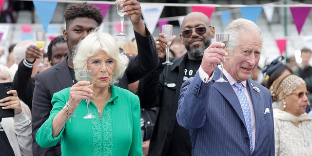 Camilla, Duchess of Cornwall and Prince Charles, Prince Of Wales cheers with glasses of champagne at the Big Jubilee Lunch at The Oval on June 5, 2022 in London, England.