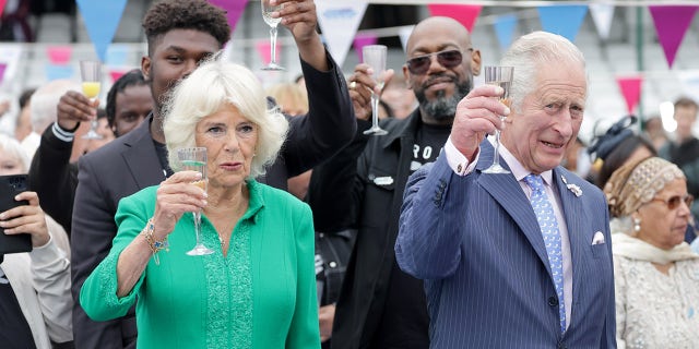 Camilla, Duchess of Cornwall and Prince Charles, Prince Of Wales cheers with glasses of champagne at the Big Jubilee Lunch at The Oval on June 5, 2022 in London, England.