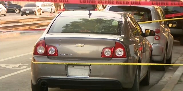 The cordoned off crime scene where bullets entered a car, striking a 5-month-old baby inside.