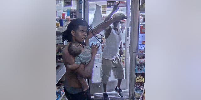 Detroit man with baby attempts to deter gunman who barrels into store.