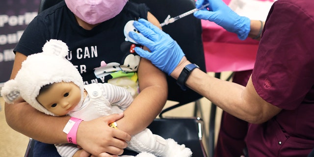 First grade student, seven-year-old Rihanna Chihuaque, receives a covid-19 vaccine