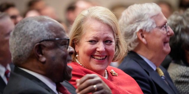 Justice Clarence Thomas sits with his wife Virginia Thomas while he waits to speak at the Heritage Foundation on Oct. 21, 2021, in Washington.
