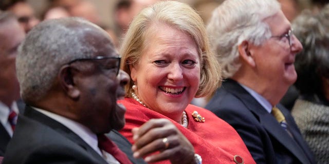 Associate Supreme Court Justice Clarence Thomas sits with his wife and conservative activist Ginni Thomas while he waits to speak at the Heritage Foundation on October 21, 2021 in Washington, DC. 