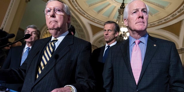 File-Senator Mitch McConnell (left) and Senator John Cornyn (right) speak with reporters after a private policy meeting at the Washington Capitol on Tuesday, March 8, 2016.