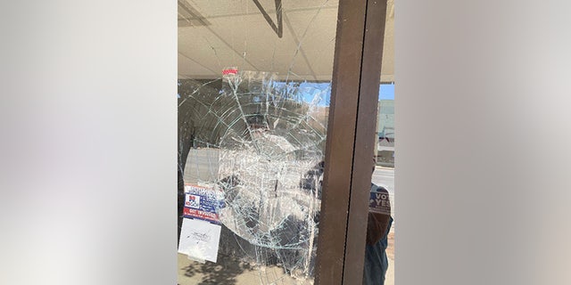 The vandal threw a rock at the entrance the Cowley County GOP headquarters, as shown here.