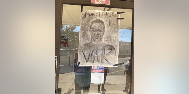 A poster left by the vandal on the entranceway to the Cowley County GOP headquarters.