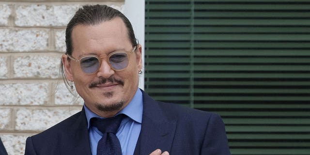 Actor Johnny Depp smiles at fans after a break on the final day of his defamation trial against Amber Heard in Fairfax, Va., May 27, 2022.