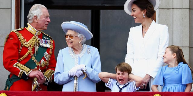 Britain's Queen Elizabeth II, Prince Charles and Catherine, Duchess of Cambridge, along with Princess Charlotte and Prince Louis.