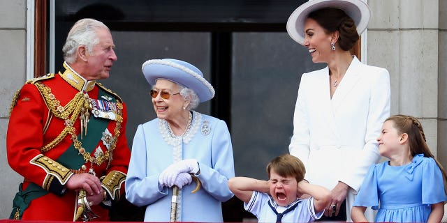 Britain's Queen Elizabeth II, Prince Charles and Catherine, Duchess of Cambridge, along with Princess Charlotte and Prince Louis.