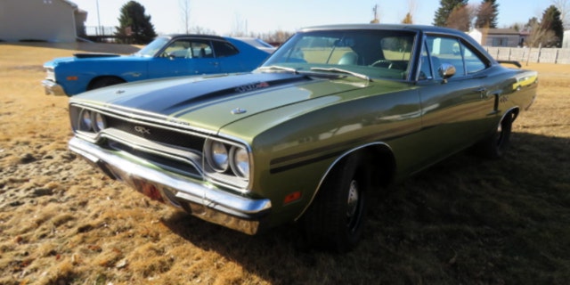 A 1973 Dodge Dart Sport coupe and 1970 Plymouth GTX coupe are among Moser's collection.