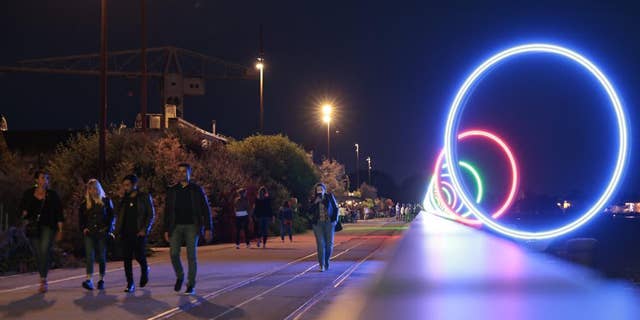 Youths walk on quay Des Anneaux near the Warehouse nightclub, Wednesday, May 18, 2022, in Nantes, western France.