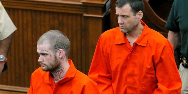 In this June 21, 2017, file photo, Ricky Dubose, left, and Donnie Russell Rowe enter the Putnam County courthouse in Eatonton, Ga.