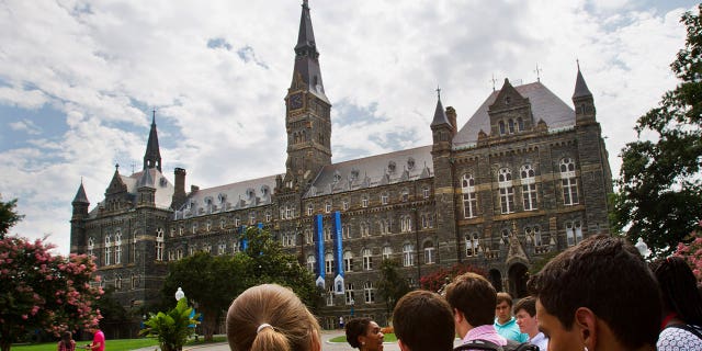 Prospective students tour Georgetown University's campus, on July 10, 2013, in Washington. Amin Khoury is scheduled to stand trial Tuesday June 7, 2022, in Boston, on charges that he bribed Georgetown University tennis coach Gordon Ernst to get his daughter into the school as a recruit. (AP Photo/Jacquelyn Martin, File)