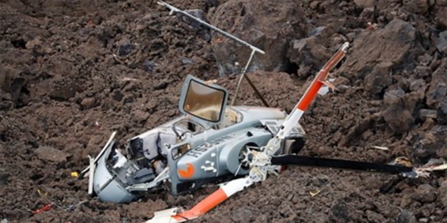 This NTSB image shows the main wreckage in lava-covered terrain. 