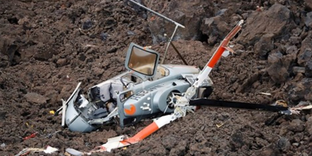 This NTSB image shows the main wreckage in lava-covered terrain. 