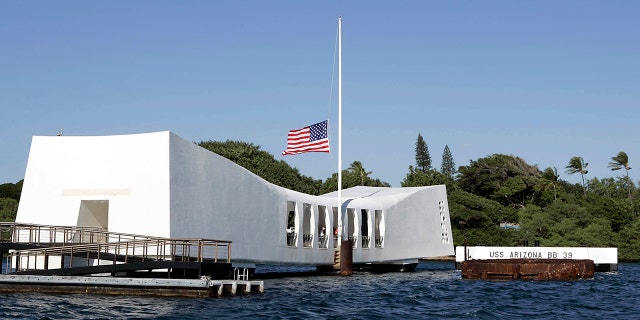 A U.S. flag flies at half-mast aboard the USS Arizona Memorial during the ceremony honoring the 64th anniversary of the surprise attack on Pearl Harbor, on Dec. 7, 2005 at Pearl Harbor, Hawaii.