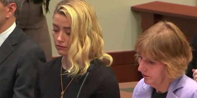 Amber Heard listening to the jury announce the verdict in her ex-husband's defamation trial.