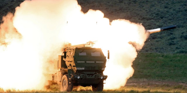 In this May 23, 2011, file photo a launch truck fires the High Mobility Artillery Rocket System (HIMARS) produced by Lockheed Martin during combat training in the high desert of the Yakima Training Center, Washington. 