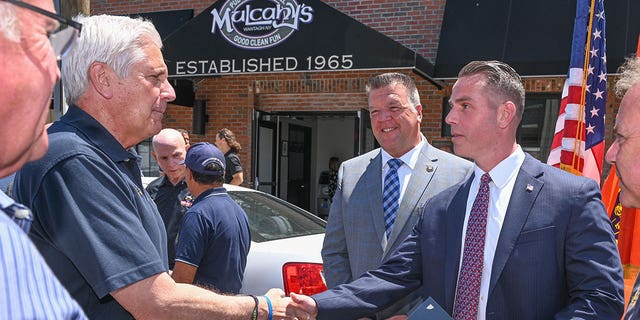 Nassau County Executive Bruce Blakeman shakes hands with promoted Det. Ryan Hines at a press event on Wednesday, June, 15, 2022. 