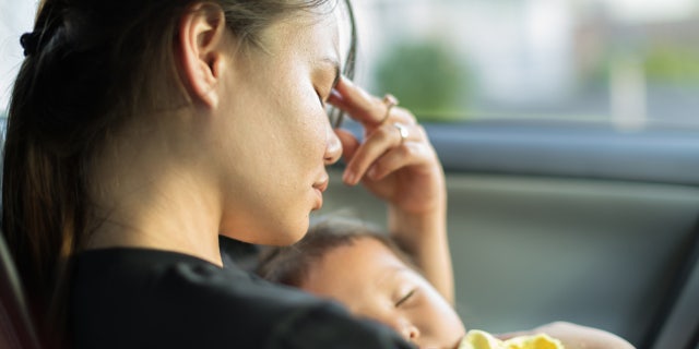 tired mother with baby