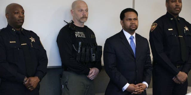 Aurora, Illinois, police officers and Aurora mayor Richard Irvin, second from right, during a news conference after a 2018 shooting incident in the city.