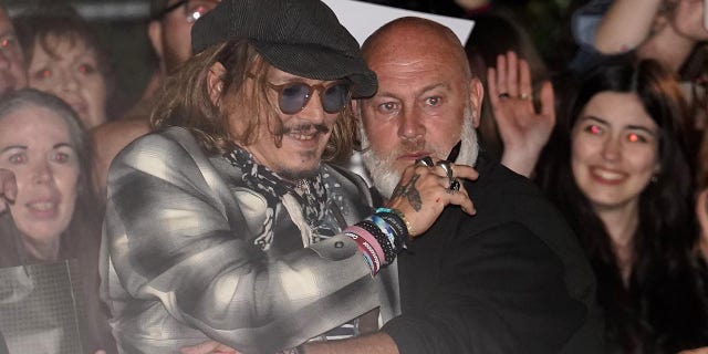 Fans mob Johnny Depp outside a theater in York, England, where he was performing with guitarist Jeff Beck Monday night.
